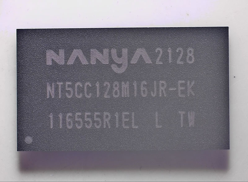 Macro photography of a Nanya DDR3 memory chip (NT5CC128M16JR-EK) showing clear laser markings and date codes.